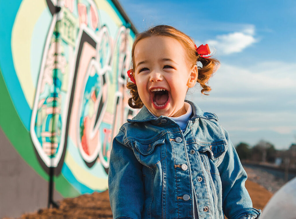 Excited Girl in front of Tifton, Georgia Mural